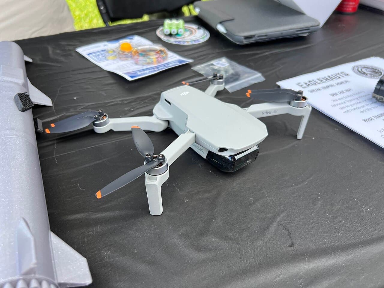 DJI Mini 4K drone unfolded on a table, top view with propellers