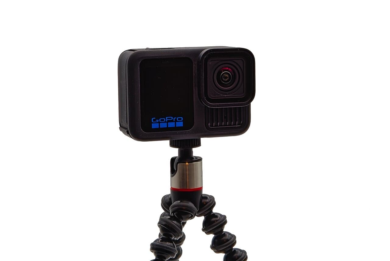 GoPro HERO13 Black on a mini tripod, three-quarter front view with front display and lens