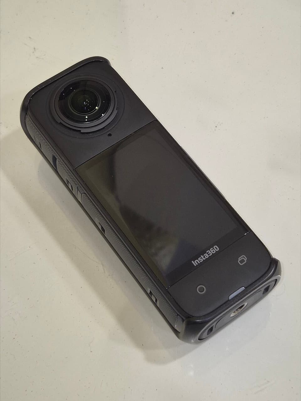 Insta360 X4 in a protective cover, front lens and touchscreen